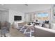 Bright room with modern furniture, wood floors, an area rug and a view of the outside at 10230 E Utah Ave, Mesa, AZ 85212