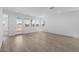 Bright room with wood floors, a back door and several windows providing plenty of natural light at 10230 E Utah Ave, Mesa, AZ 85212