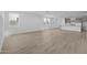 Spacious living area with light wood flooring and large windows providing ample natural light at 10230 E Utah Ave, Mesa, AZ 85212