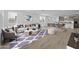 Bright living room featuring modern decor, wood floors, an area rug, and a view of the open floor plan at 10230 E Utah Ave, Mesa, AZ 85212