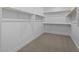 Empty walk-in closet with white walls, shelving, and carpet at 10230 E Utah Ave, Mesa, AZ 85212