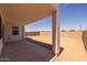 Large, covered patio with desert landscaping offers plenty of room for outdoor activities in the fully fenced yard at 10236 E Utah Ave, Mesa, AZ 85212