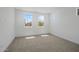 Bright bedroom featuring natural light from three windows and neutral carpet at 10236 E Utah Ave, Mesa, AZ 85212