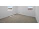 Unfurnished bedroom featuring natural light from two windows and neutral carpet at 10236 E Utah Ave, Mesa, AZ 85212