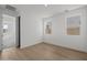 Bright, empty bedroom with wood flooring and three windows at 10236 E Utah Ave, Mesa, AZ 85212