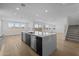 Bright, open-concept kitchen with an island featuring modern appliances and a clean, streamlined design at 10236 E Utah Ave, Mesa, AZ 85212