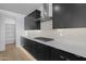 Modern kitchen featuring dark cabinets, stainless steel appliances, and a stylish backsplash design at 10236 E Utah Ave, Mesa, AZ 85212
