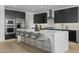 Elegant kitchen with a large island, stainless steel appliances, and barstool seating at 10236 E Utah Ave, Mesa, AZ 85212