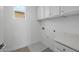 Clean, white laundry room featuring storage and sink at 10236 E Utah Ave, Mesa, AZ 85212