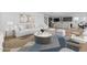 Cozy living room area with modern furnishings, seamlessly connected to the kitchen and dining areas at 10236 E Utah Ave, Mesa, AZ 85212