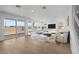 Bright living room with light wood floors and a sliding glass door leading to the backyard at 10236 E Utah Ave, Mesa, AZ 85212