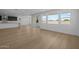 Open-concept area combining living room and kitchen, with sliding doors, plenty of light, and hardwood floors at 10236 E Utah Ave, Mesa, AZ 85212