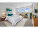 Staged main bedroom with carpet, bright natural lighting, stylish furniture, and scenic neighborhood views at 10236 E Utah Ave, Mesa, AZ 85212