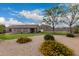 Landscaped backyard with gravel ground cover, flowering bushes, a mountain view, and a covered patio for relaxing at 1043 N 90Th Cir, Mesa, AZ 85207