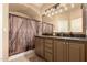 Inviting bathroom showcasing double sinks, rustic wood-look accents, decorative vanity lighting, and ample counterspace at 1043 N 90Th Cir, Mesa, AZ 85207