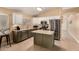 Well-lit kitchen with stainless steel appliances, center island, and a harmonious blend of white and green cabinets at 1043 N 90Th Cir, Mesa, AZ 85207