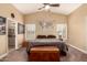 Relaxing main bedroom with a ceiling fan, plush carpet, and decorative wall art for a tranquil retreat at 1043 N 90Th Cir, Mesa, AZ 85207