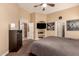 Spacious main bedroom featuring a TV, closet space, neutral walls and carpet providing a calm personal space at 1043 N 90Th Cir, Mesa, AZ 85207