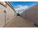 Long side yard featuring rock ground cover and a block fence, providing a low-maintenance outdoor space at 1043 N 90Th Cir, Mesa, AZ 85207