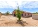 The home's backyard features desert landscaping and a small storage shed at 11266 E Dartmouth Cir, Mesa, AZ 85207