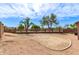 The expansive backyard features desert landscaping and mature trees at 11266 E Dartmouth Cir, Mesa, AZ 85207