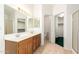 Bright bathroom with a double sink vanity and tile flooring, providing a clean and functional space at 11266 E Dartmouth Cir, Mesa, AZ 85207