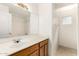 Bathroom features a vanity with ample countertop space, a large mirror, and a separate shower/tub area at 11266 E Dartmouth Cir, Mesa, AZ 85207