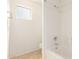 Bright bathroom with a standard tub and shower, complemented by neutral tile flooring and a window for natural light at 11266 E Dartmouth Cir, Mesa, AZ 85207