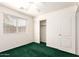 Bright bedroom with a large window, a ceiling fan, and a closet with sliding doors at 11266 E Dartmouth Cir, Mesa, AZ 85207