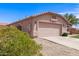 Single-story home with a two-car garage, desert landscaping, and a well-maintained driveway at 11266 E Dartmouth Cir, Mesa, AZ 85207