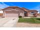 Charming single-story home featuring a two-car garage, desert landscaping, and a well-maintained lawn at 11266 E Dartmouth Cir, Mesa, AZ 85207