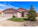 Charming single-story home featuring a two-car garage, desert landscaping, and a well-maintained lawn at 11266 E Dartmouth Cir, Mesa, AZ 85207