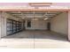 Spacious two-car garage featuring ample storage space and a sturdy overhead door at 11266 E Dartmouth Cir, Mesa, AZ 85207