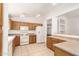Functional kitchen with oak cabinets, white appliances, and tile flooring, offering a practical cooking space at 11266 E Dartmouth Cir, Mesa, AZ 85207