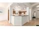 Inviting kitchen featuring a breakfast bar and ample lighting, perfect for casual dining and entertaining at 11266 E Dartmouth Cir, Mesa, AZ 85207