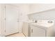 Convenient laundry room equipped with a washer, dryer, and overhead shelving for storage at 11266 E Dartmouth Cir, Mesa, AZ 85207