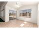 Bright sun room featuring tile flooring, ceiling fan and large windows with sliding door access to the backyard at 11266 E Dartmouth Cir, Mesa, AZ 85207