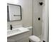 Clean bathroom with white vanity, stylish mirror, and walk-in shower with modern fixtures at 1301 N 44Th St, Phoenix, AZ 85008