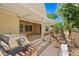 Stylish covered patio featuring an outdoor kitchen, lush garden, and plenty of shade for outdoor relaxation at 13134 W Los Bancos Ct, Sun City West, AZ 85375