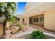 Tranquil backyard featuring a covered patio, water feature, and lush landscaping for relaxed outdoor living at 13134 W Los Bancos Ct, Sun City West, AZ 85375