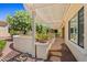 Peaceful covered patio offering shade and privacy, surrounded by mature landscaping for a serene outdoor experience at 13134 W Los Bancos Ct, Sun City West, AZ 85375