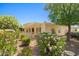 Beautifully landscaped backyard with covered patio and lush flowering bushes at 13134 W Los Bancos Ct, Sun City West, AZ 85375