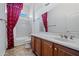 Traditional bathroom featuring wood cabinets, single sink and shower at 13134 W Los Bancos Ct, Sun City West, AZ 85375