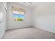Bedroom with a ceiling fan, carpet, and a window with a colorful curtain at 13134 W Los Bancos Ct, Sun City West, AZ 85375