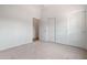 Bedroom featuring carpet, closet and view to the hallway at 13134 W Los Bancos Ct, Sun City West, AZ 85375
