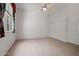 Bedroom with a ceiling fan, carpet, and a window with colorful curtains at 13134 W Los Bancos Ct, Sun City West, AZ 85375