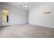 Bright bedroom featuring neutral carpet, access door, and ample natural light at 13134 W Los Bancos Ct, Sun City West, AZ 85375