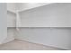 Walk-in closet features carpeted flooring and multiple shelves for storage at 13134 W Los Bancos Ct, Sun City West, AZ 85375