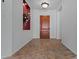 Inviting entryway with tile flooring and a solid wood front door at 13134 W Los Bancos Ct, Sun City West, AZ 85375