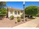 Inviting single-story home with manicured landscaping and a driveway leading to an attached garage at 13134 W Los Bancos Ct, Sun City West, AZ 85375